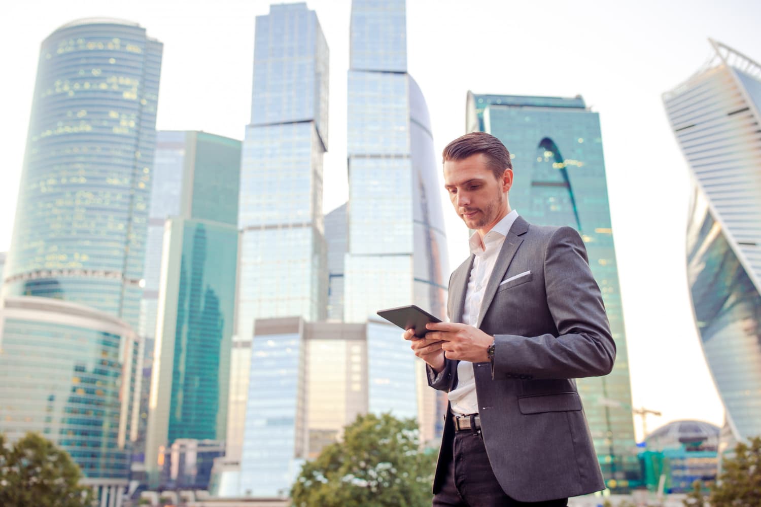 Property manager in a suit holding a tablet